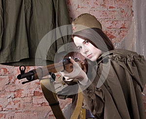 Woman in Russian military uniform shoots a rifle. Female soldier during the second world war.