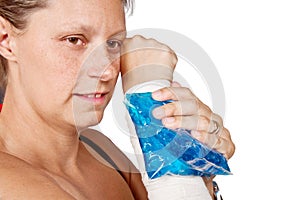 Woman's arm with bandage and ice painkiller