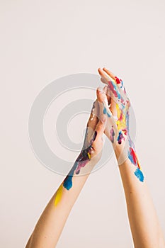 Woman`s artist`s hands in paints isolated on a white background. Concept photography for art or women`s blog