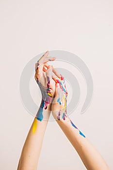 Woman`s artist`s hands in paints isolated on a white background. Concept photography for art or women`s blog