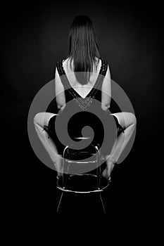 Woman's back sitting on the barchair