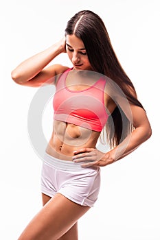 Woman`s body in sport wear on white with copy space. Sporty girl with slim figure isolated. Perfect abdomen