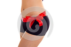 Woman`s buttocks with red bowtie