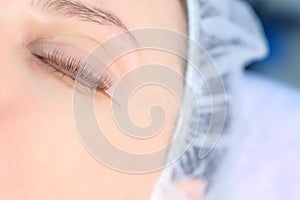 Woman`s closed eye with bending lashes on curlers, lift eyelashes laminaton.