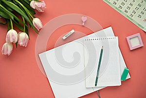 Woman`s desktop with calendar, black pencil, pencil and tulips. - planning women`s day.