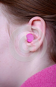 Woman's ear with earplug