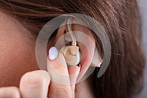 Woman`s Ear With Hearing Aid