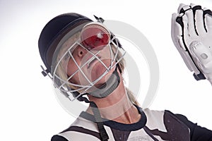 Woman's face in helmet being hit by cricket ball