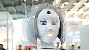 Woman`s face on a high-tech robot. Media. High-tech robot at the exhibition. Robotic of a human like droid robot