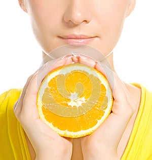 Woman's face with juicy orange