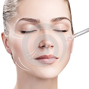 Woman`s face with lifting arrows and cosmetics oil