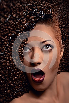 Woman's face over coffee beans