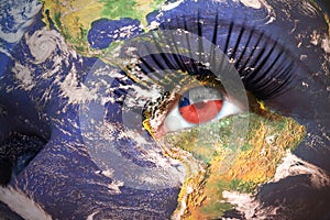 Woman`s face with planet Earth texture and chilean flag inside the eye.