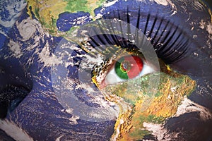 Woman`s face with planet Earth texture and portuguese flag inside the eye
