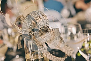 Woman's fascinator on champagne glass