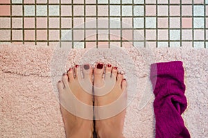A Womans Feet on Bath Mat