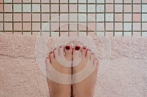 A Womans Feet on Bath Mat photo