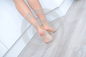 Woman`s feet on the floor
