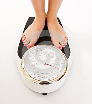 Woman's feet on large weighing scales