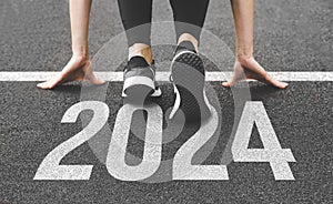 Woman& x27;s feet ont the road, begin to run, fstart of New year 2024, planning, goal, and new year resolution.