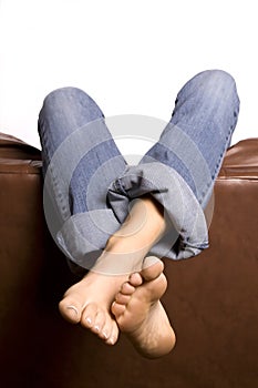 Woman's feet over couch crossed