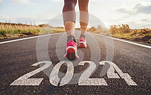 Woman's feet on the road, Starting the New Year 2024 with a run