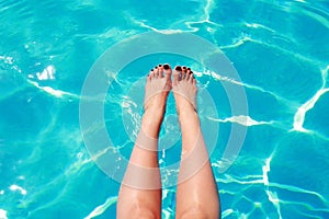 Woman's feet in a swimming pool