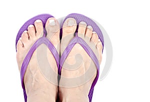 Woman's Feet Wearing Purple Flop Flops