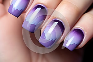 Woman\'s fingernails with purple ombre colored nail polish design