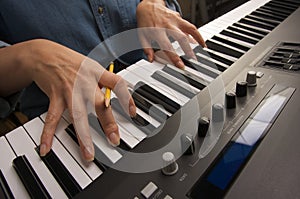 Woman's Fingers on Digital Piano Keys