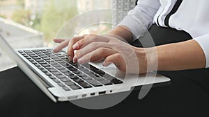 Woman`s fingers typing on laptop keyboard. Female hands type on laptop keyboard. Businesswoman working on tablet computer. Human h