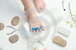 Woman`s foot with toe separator