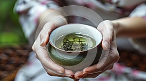 A Woman\'s Gentle Grasp on a Chawan Containing the Delicate Essence of Green Oolong