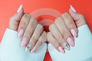 A woman's hand with a beautiful pink manicure. Manicure in pink, close-up.