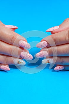 A woman\'s hand with a beautiful pink manicure. Manicure in pink, close-up.