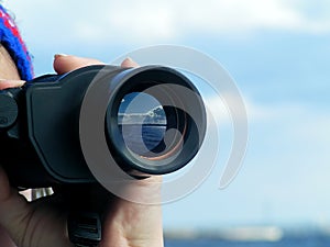 Woman's hand with binocular