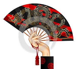 Woman`s hand with a black chinese fan with gold decorative grago