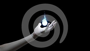 Woman`s hand with blue fire sphere in the middle of the screen, 4k footage with special effects on black background