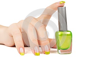 Woman's hand with a bottle of green nail polish