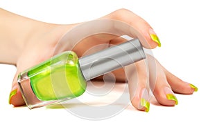 Woman's hand with a bottle of green nail polish