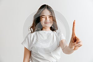 Woman`s hand with finger on gray background