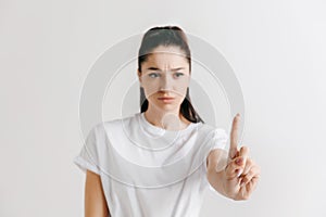 Woman`s hand with finger on gray background