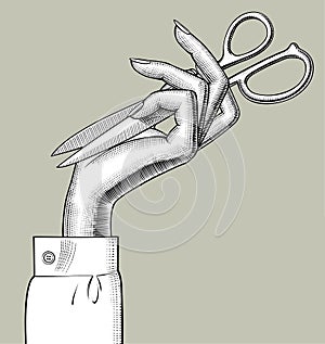 Woman`s hand with folded scissors