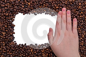 Woman's hand on a frame of coffee beans