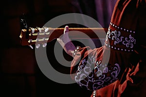 woman's hand on the fretboard of an acoustic guitar