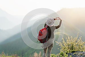 Woman`s hand gesturing a heart shape