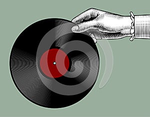 Woman`s hand with a gramophone record photo