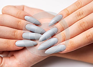 Woman's hand with grey nail polish photo