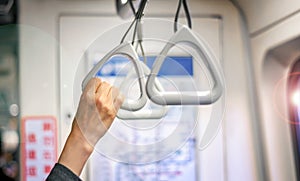 Woman`s Hand Hold on to a Handle Bar on a Public Transportation while Standing