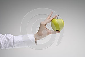 Woman's hand holding an apple